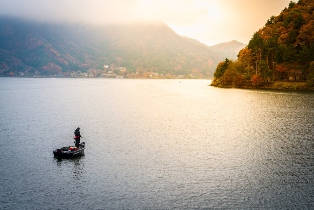 A traditional fisherman balancing on one leg on Inle Lake, Myanmar.